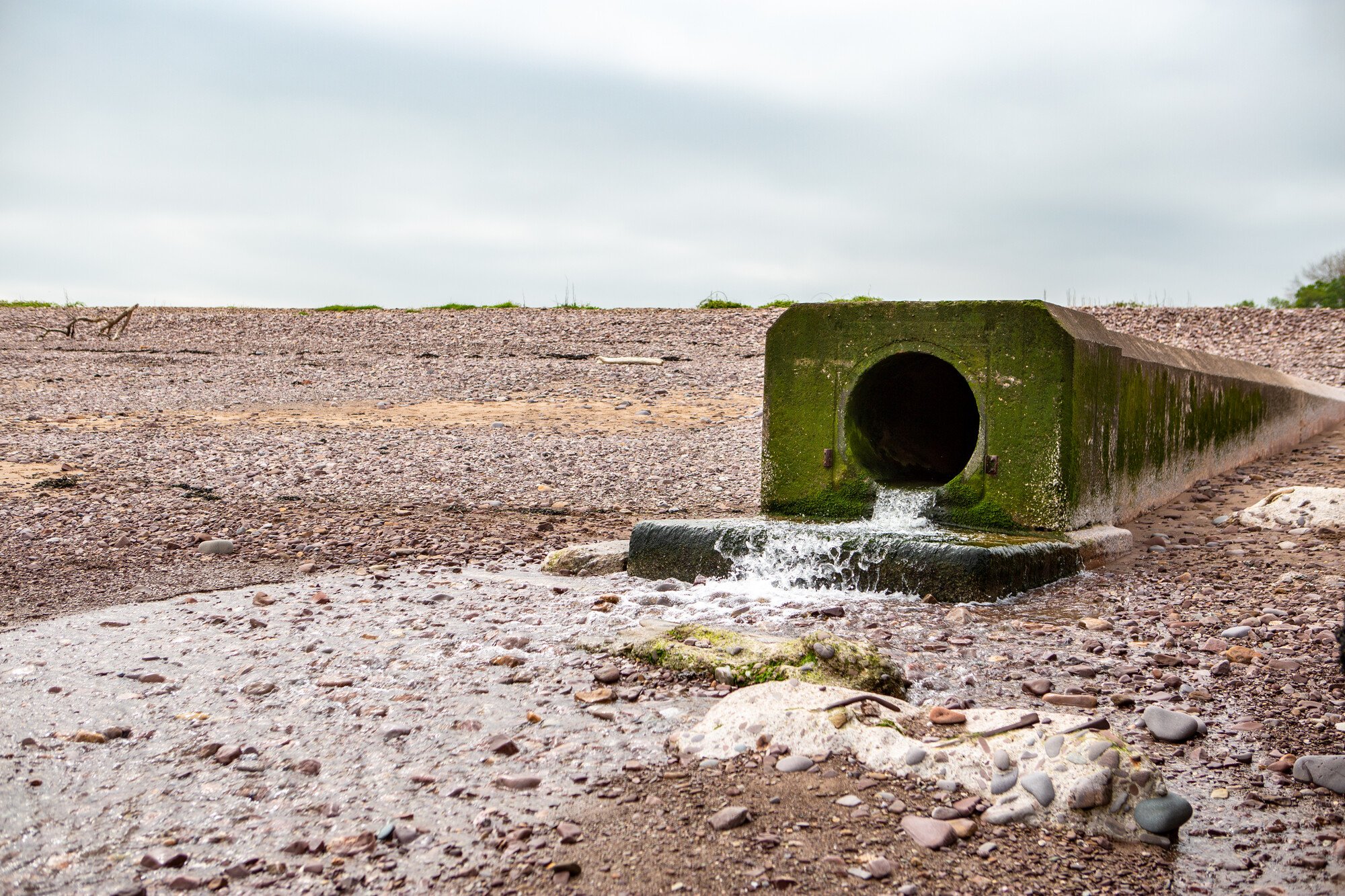 Combined Sewer Overflow spilling onto a beach