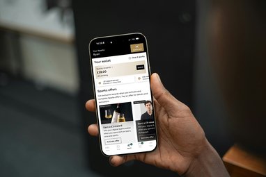 A phone being held up. The Sparks app can be see on the screen.