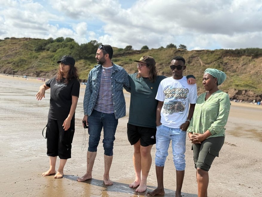 5 adults standing on Filey beach