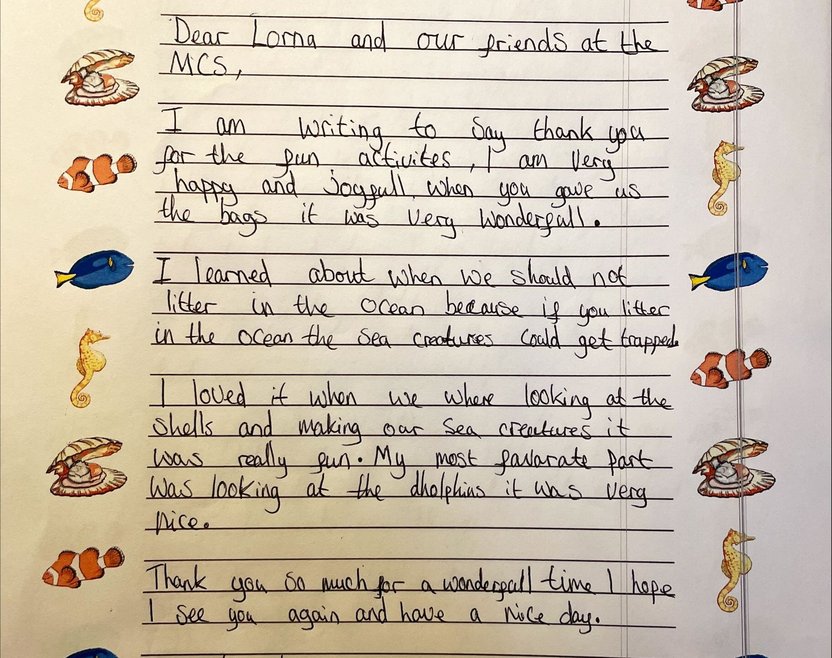 A child's letter written to the lead of the One Ocean Roadshow thanking them for the fun activities. Sea animals line the paper on both sides.
